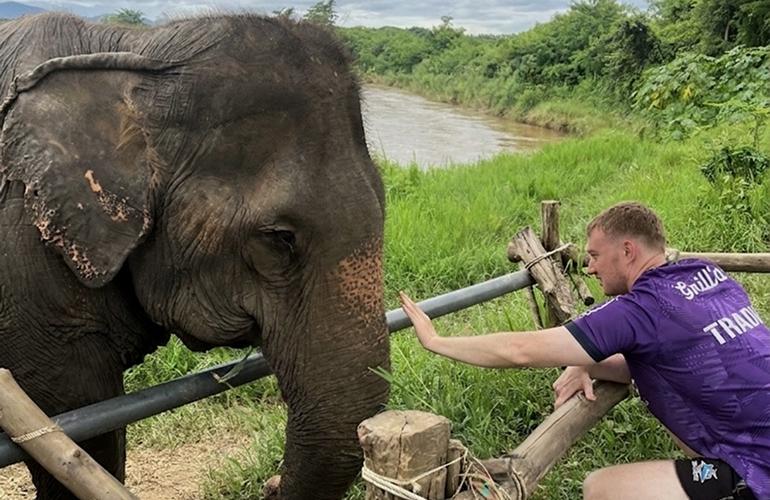 Jordan petting an elephant in Thailand